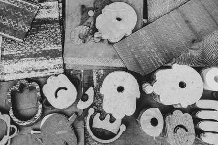 Figures carved from ceramics and stone black and white photo close-up