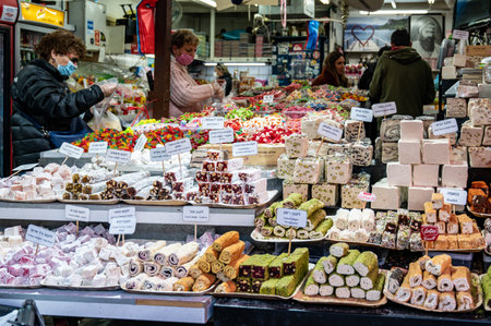 TEL AVIV, ISR - January 25, 2022: Israelis shop at the Carmel Shuk HaCarmel Market in Tel Aviv, Israel. This is a very popular market in Tel Aviv where they sell confectionery as well as fruits and vegetables.のeditorial素材