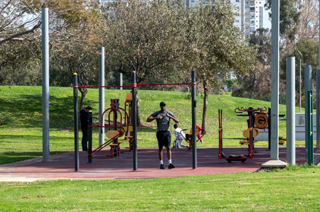 Netanya, Israel - February 2, 2022. Winter Lake Park. A man goes in for sports in the park in the morning.のeditorial素材