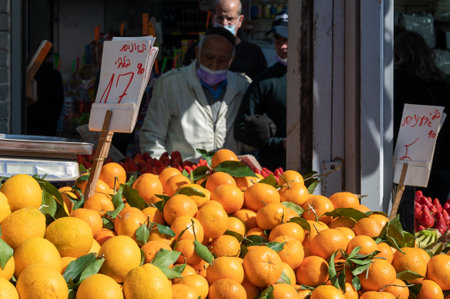 TEL AVIV, ISR - January 25, 2022: Israelis shop at the Carmel Shuk HaCarmel Market in Tel Aviv, Israel. This is a very popular market in Tel Aviv where they sell confectionery as well as fruits and vegetables.のeditorial素材