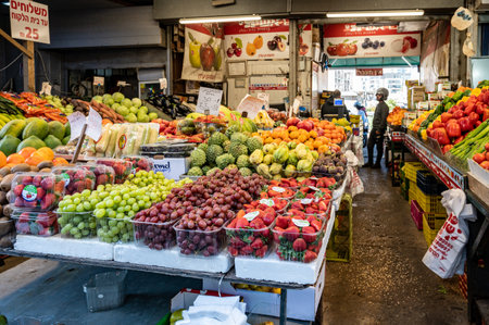 TEL AVIV, ISR - January 25, 2022: Israelis shop at the Carmel Shuk HaCarmel Market in Tel Aviv, Israel. This is a very popular market in Tel Aviv where they sell confectionery as well as fruits and vegetables.のeditorial素材