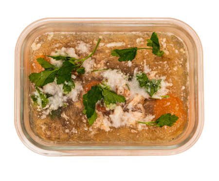 Traditional Russian food for the New Year. Jellied beef, pork, carrots, onions, celery and herbs. Tasty food. The dish is served cold. isolated on a white background. top viewの写真素材