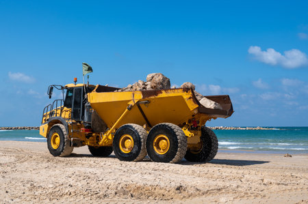 A large mining truck transports stones to build breakwaters to protect a beach in Netanya, Israel....