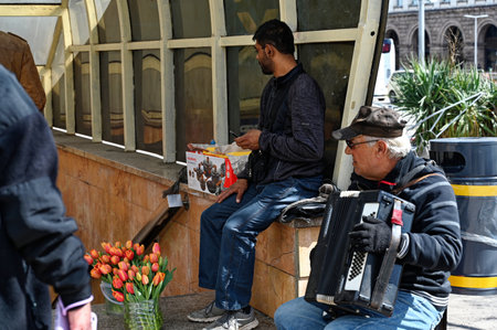 Bulgaria, Sofia, April 15, 2023: people in the Vitosha Boulevard. Street musician. High quality photoのeditorial素材
