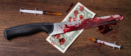 a bloody knife and banknotes on the table, nearby there are syringes for injecting heroin. High quality photoの写真素材