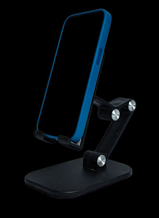 Mobile phone is placed on a table stand. Isolated on a transparent background. High quality photoの写真素材