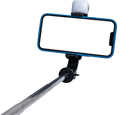 Selfie stick and smartphone on white background with white cut out screen. High quality photoの写真素材