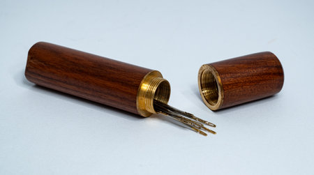 Set of sewing needles in wooden case isolated on white background. High quality photoの写真素材