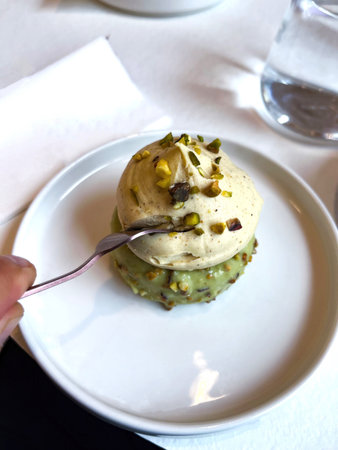 One almond cake on a plate in a cafe on a table.の写真素材