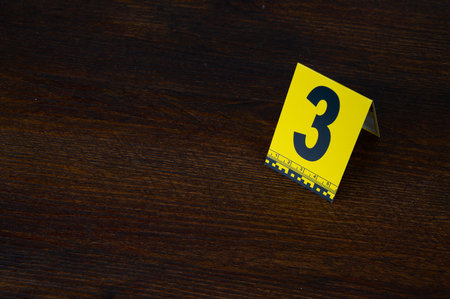 Yellow crime scene evidence marker number 3 on the floor in the room. High quality photoの写真素材