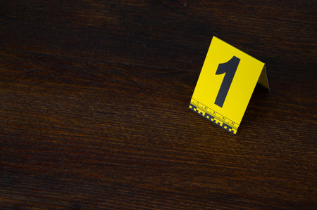 Yellow evidence marker number 10 on the floor in the room. High quality photoの写真素材