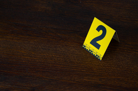 Yellow crime scene evidence marker number 2 on the floor in the room. High quality photoの写真素材