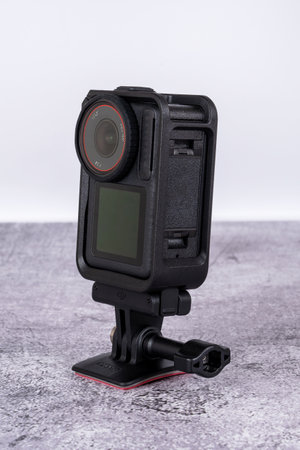 black action camera front view placed on the table. High quality photo