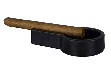 a lit cigar lies on an ashtray on a transparent background. High quality photoの写真素材