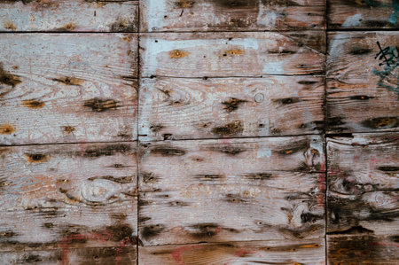 old wooden boards on the wall with black nail stains. used as a background. High quality photo