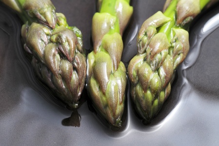 wild asparagus in various situations of their preparation in the kitchen macro images