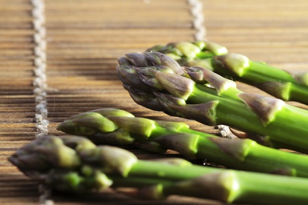 wild asparagus in various situations of their preparation in the kitchen macro imagesの写真素材