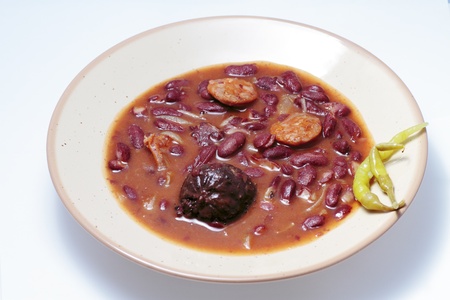 Typical Spanish cuisine dish with red beans and chorizo sausage accompanied by chilliの写真素材