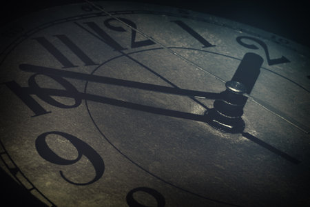 The concept of gray everyday commonness and routine. The clock face on the dark Gothic background.の写真素材