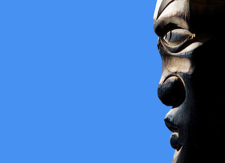 Wooden sculpture of a shaman looking to the side. face in profile