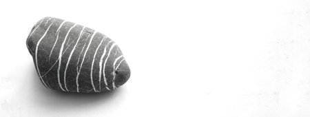 Striped stone on white isolated background. abstract nature patternの写真素材