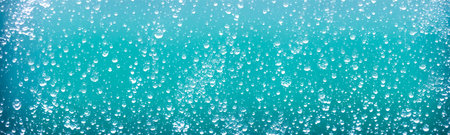 Droplets of water create refreshing and realistic sweat texture on glass window. Transparent...