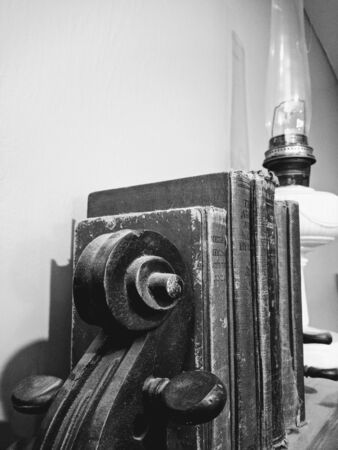 old books on shelf with oil lampの写真素材