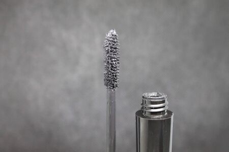 black mascara tube and brush against black backgroundの写真素材