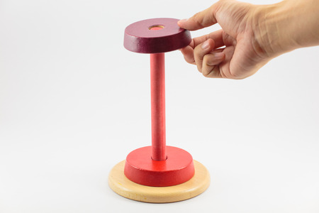 Pyramid build from colored wooden rings isolate on white background, Step 2の写真素材
