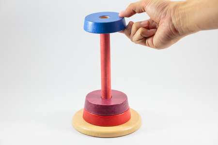 Pyramid build from colored wooden rings isolate on white background, Step 3の写真素材
