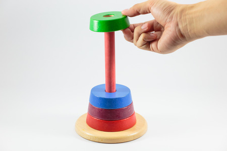 Pyramid build from colored wooden rings isolate on white background, Step 4の写真素材