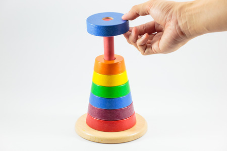Pyramid build from colored wooden rings isolate on white background, Step 7の写真素材