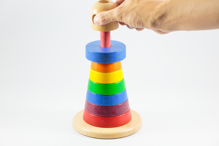 Pyramid build from colored wooden rings isolate on white background, finishの写真素材