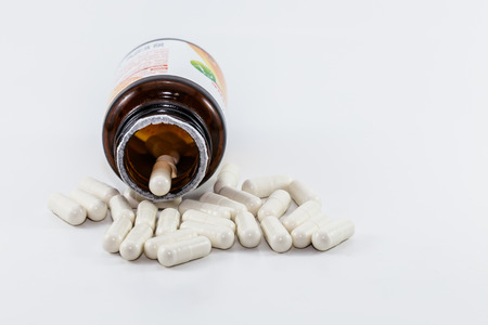 pills and pill bottle on white backgroundの写真素材