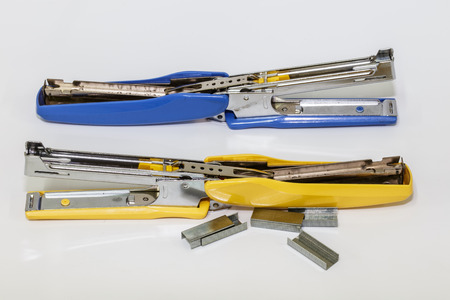 Two Staplers with staples on a white backgroundの写真素材