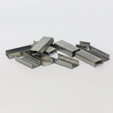 Stack of metal staples. Isolated on a white background.の写真素材