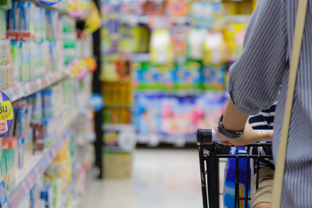 Closeup of woman with her son sit on shopping cart.の写真素材