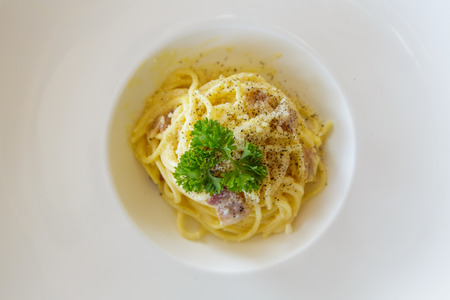 spagetti ham and mushroom on white dishの写真素材