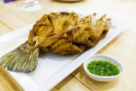 Deep Fried fish with spicy seafood sauce, Famouse Thai seafood menuの写真素材