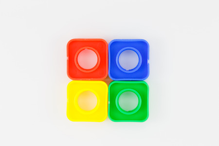 colorful plastic toy, bolts and nuts on a white background