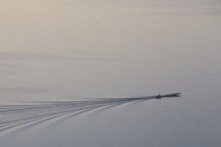 A man on a ferryboat on the lakeの写真素材