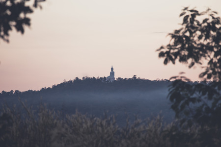 lighting sun and big buddha on mountainの写真素材
