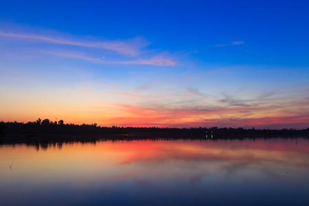 Beautiful lake landscape with vibrant sunset.の写真素材