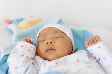 Sleeping baby with white hatの写真素材