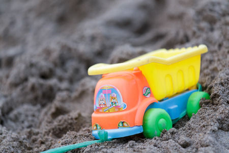 Plastic toy truck on the sandの写真素材