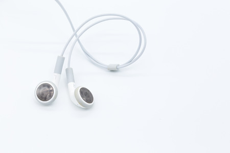 White earbuds isolated on white backgroundの写真素材