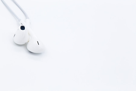 White earbuds isolated on white backgroundの写真素材