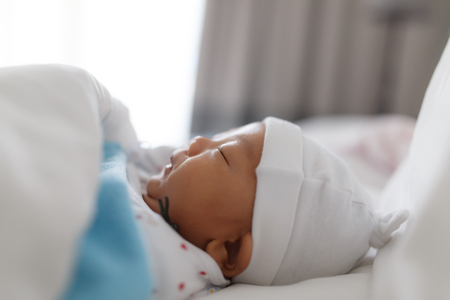 Sleeping baby with white hatの写真素材