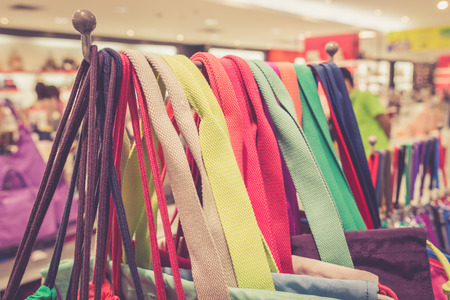 Shoulder strap bag hanging for sale in department storeの写真素材