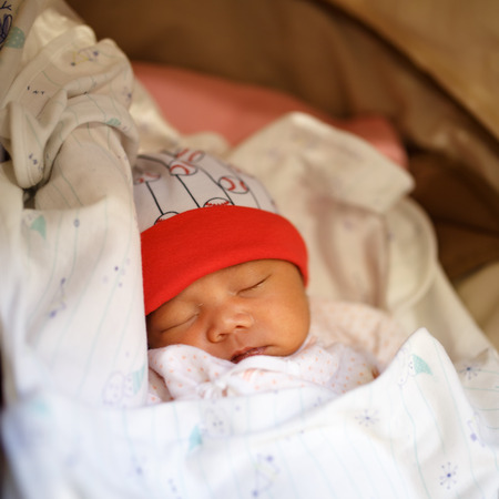 Newborn baby sleep in a stroller outdoorsの写真素材